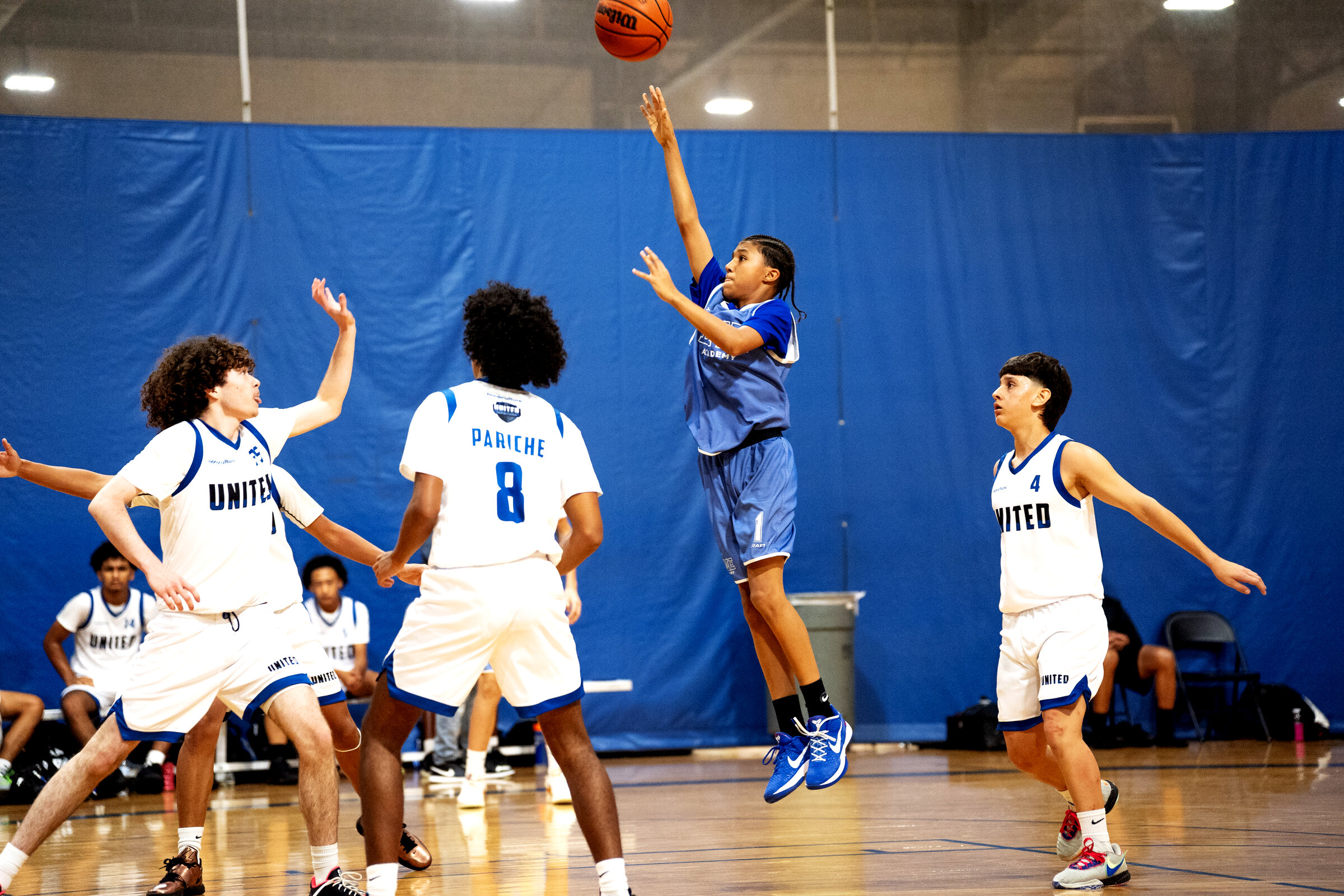 Basketball player performing a jump shot on the DME Academy court