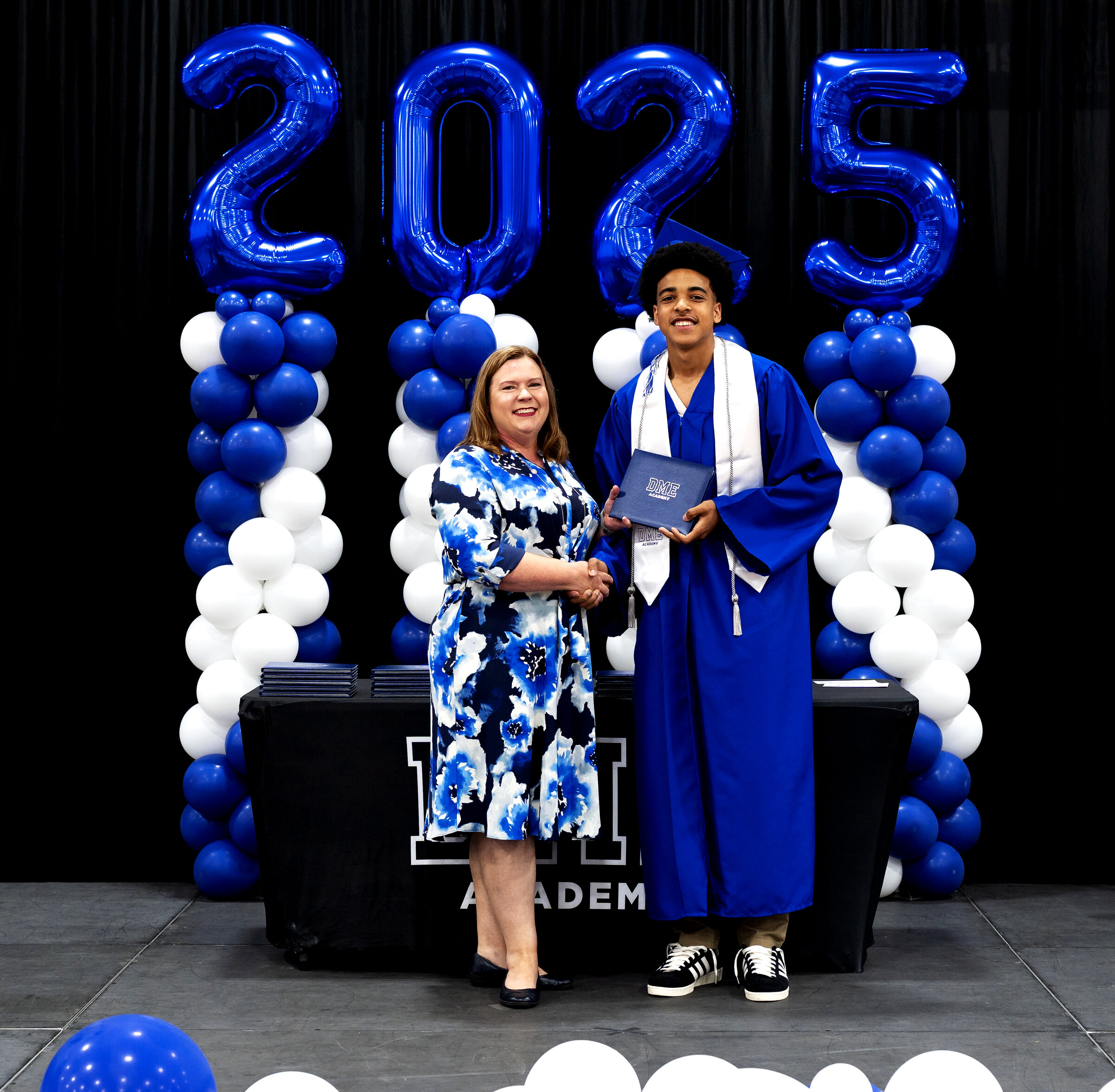 DME Academy graduate with diploma